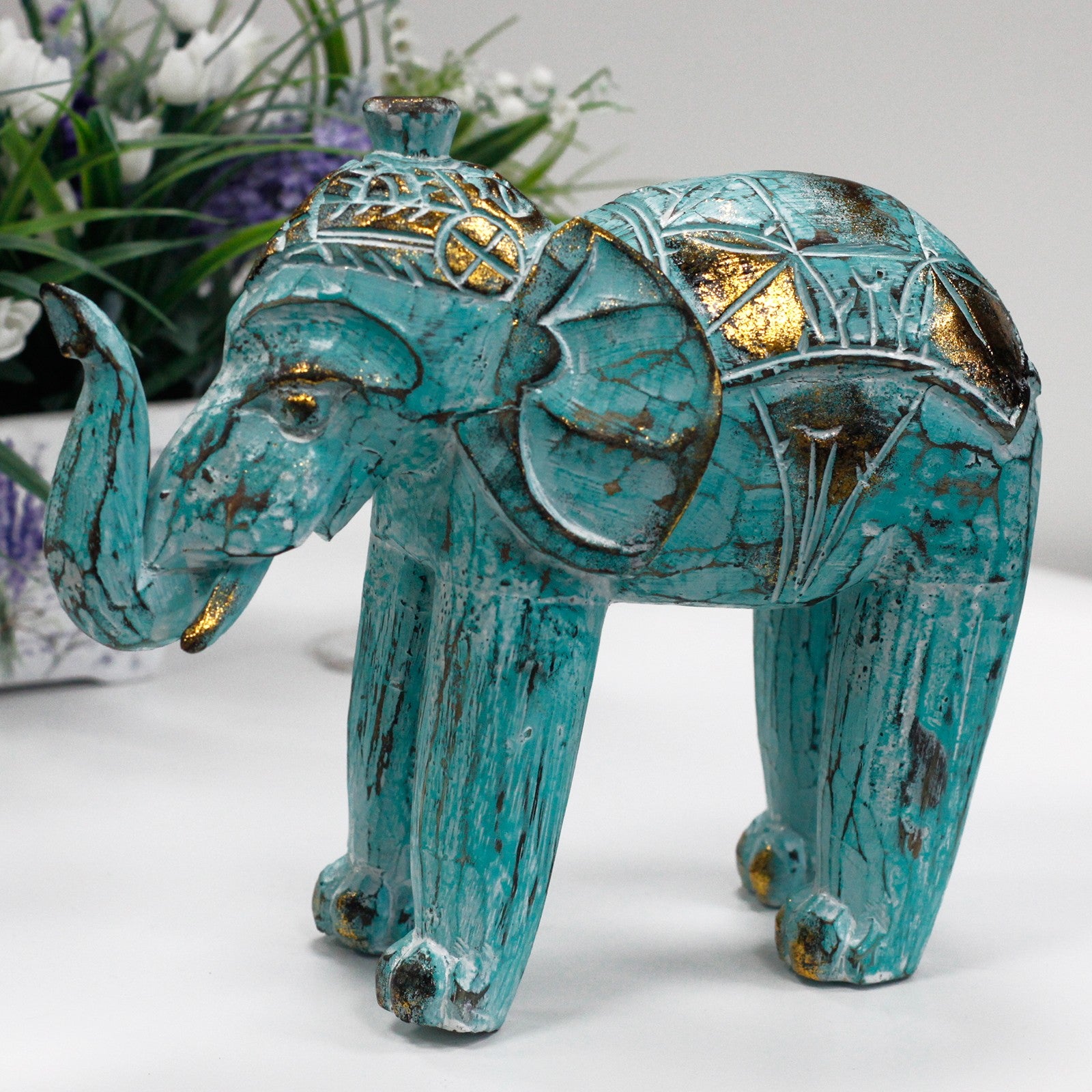 Elefante turquesa-oro en madera de albesia tallado a mano